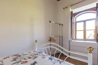 a bedroom with a bed and a window at Solar da Rosa & Solar da Tirosa in Boliqueime