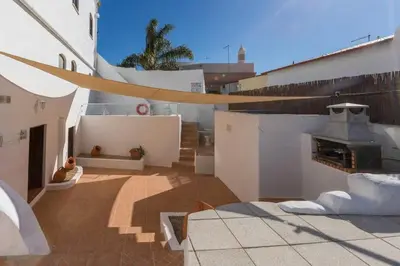 a rooftop patio with a fireplace on a building at Solar da Rosa & Solar da Tirosa in Boliqueime