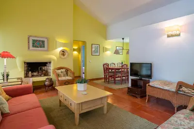 a bedroom with a wooden bed with two lamps and a dresser at BmyGuest - Falésia Beach Villa in Albufeira