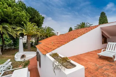 a living room with a red couch and a table at BmyGuest - Falésia Beach Villa in Albufeira