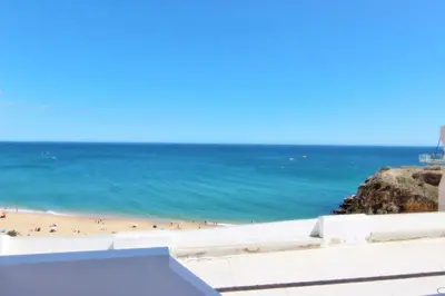 a view of a beach with people in the water at Casa dos Tios in Albufeira