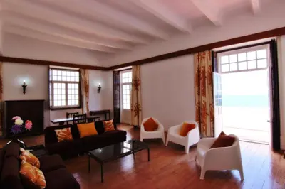 a living room with a couch and chairs at Casa dos Tios in Albufeira