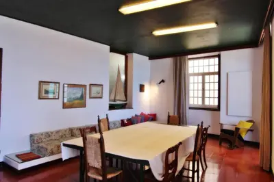 a dining room with a table and a couch at Casa dos Tios in Albufeira
