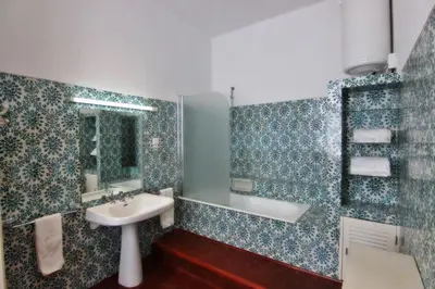 a bathroom with a sink and a bath tub at Casa dos Tios in Albufeira