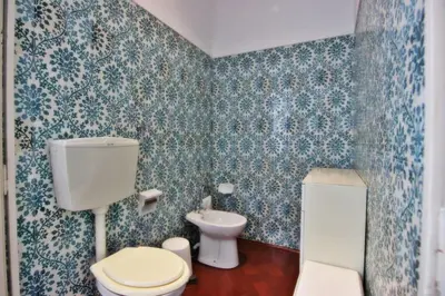 a bathroom with a toilet and a sink at Casa dos Tios in Albufeira