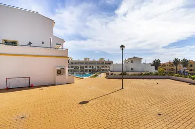 a courtyard with a volley ball court in front of a building at Vilamoura - Cozy and Quiet Holiday Apartment in Vilamoura