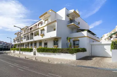 a white building on the side of a street at Vilamoura - Cozy and Quiet Holiday Apartment in Vilamoura