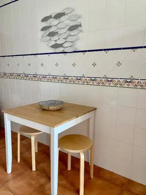 a table with two chairs and a bowl on it at Vilamoura - Cozy and Quiet Holiday Apartment in Vilamoura