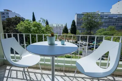 a white table and chairs on a balcony at Greenth Avenue in Faro