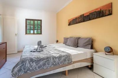 a small white house with a table and chairs at Albufeira Sunny Home for Families in Albufeira