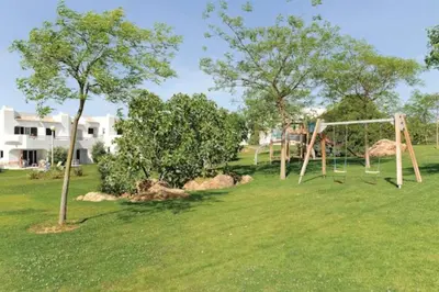 a park with a swing set in the grass at Albufeira Sunny Home for Families in Albufeira