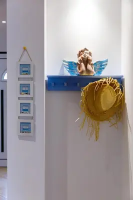 a statue of an angel on a blue shelf at Falésia Beach Villa by The Portuguese Butler in Olhos de Água
