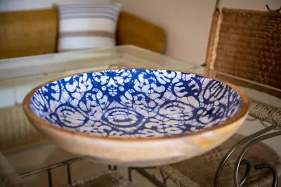 a blue and white bowl sitting on a glass table at Epic Falésia Apartment by The Portuguese Butler in Olhos de Água