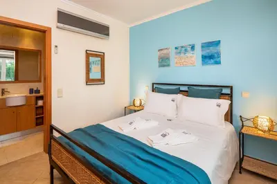 a bedroom with a bed with towels on it at Epic Falésia Apartment by The Portuguese Butler in Olhos de Água