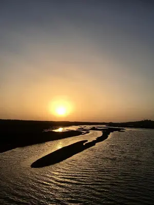 a sunset over a body of water with the sun setting at Victory Village Sea Views in Quinta do Lago