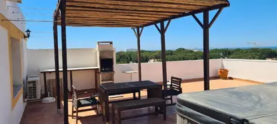 a row of chairs and tables on a patio at Penthouse with panoramic view in Vilamoura