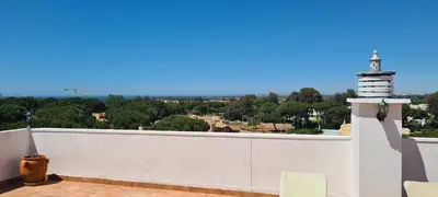 a hallway with a room with a bed and a living room at Penthouse with panoramic view in Vilamoura