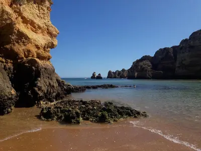 a view of a beach with rocks in the water at Quinta Cosy in Paderne