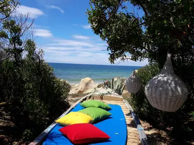 a row of pillows on a table on the beach at Quinta Cosy in Paderne