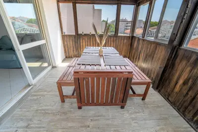 a wooden table on a balcony with a vase on it at Albufeira Center Old Town, 8ppl, 5min Fishermans beach in Albufeira