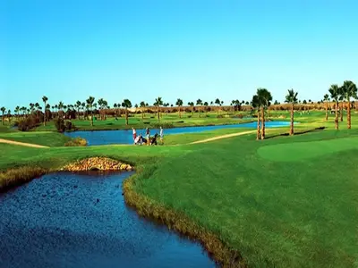 a group of people on a golf course next to a river at Luxury Apartment, 3 min Walk to Beach, Albufeira in Guia