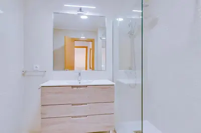 a bathroom with a sink and a mirror at Tália IV - City Center - Vilamoura in Vilamoura