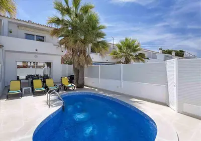 a swimming pool in the backyard of a house at Vicky Rae Beach House - Vale do Lobo in Almancil