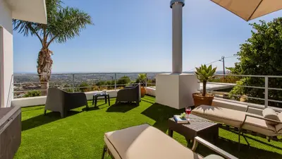 an outdoor patio with grass and a view of the ocean at Villa Mebahel - Boliqueime in Boliqueime