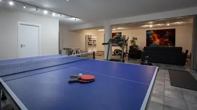 a blue ping pong table in a living room at Villa Mebahel - Boliqueime in Boliqueime