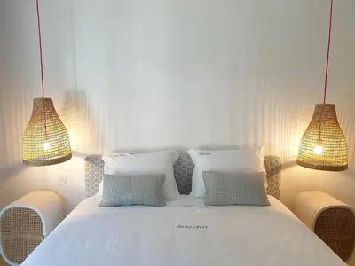 a bedroom with a white bed with two lights at Villa Azul - Clever Details, Luxury villa, private pool, access to a club with tennis court, playground, communal pools in Vilamoura