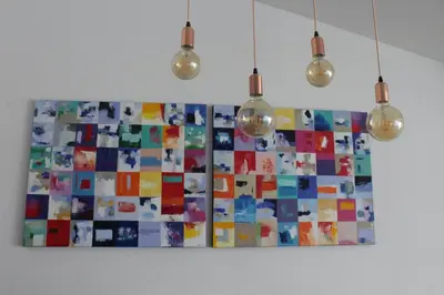 a painting hanging on a wall with three lights at Algarve Beach House with Heated Pool and Jacuzzi in Albufeira