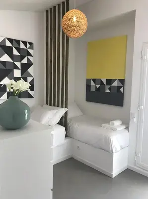 a bedroom with two beds and a vase with flowers at Algarve Beach House with Heated Pool and Jacuzzi in Albufeira