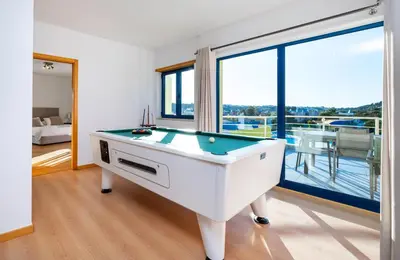 a pool table in a room with a balcony at Penthouse 160sqm wide Terraces Pool view & private Hot Tub & Parking in Albufeira