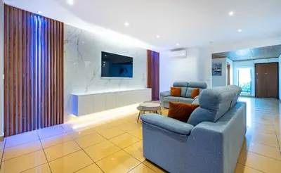 a living room with a couch and a tv at Penthouse 160sqm wide Terraces Pool view & private Hot Tub & Parking in Albufeira