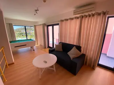 a living room with a couch and a pool table at Penthouse 160sqm wide Terraces Pool view & private Hot Tub & Parking in Albufeira