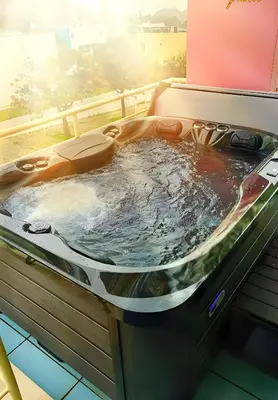 a jacuzzi tub in a room with the sun shining at Penthouse 160sqm wide Terraces Pool view & private Hot Tub & Parking in Albufeira