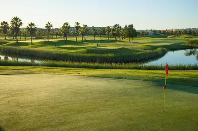 a view of a golf course with a pond at Apartamentos Vila das Lagoas – Salgados in Guia