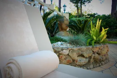 a statue of a woman in a garden at Casa Roma in Almancil