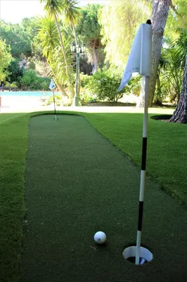 a golf ball on a putting green with a putter at Casa Roma in Almancil