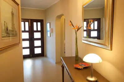 a room with a table with a vase of flowers on it at Casa Roma in Almancil