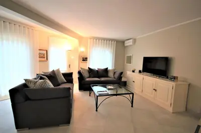 a living room with two couches and a flat screen tv at Casa Roma in Almancil