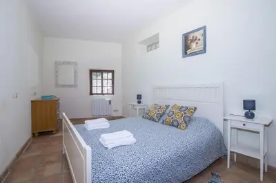 a bedroom with a bed with towels on it at Villa Angel in Loulé