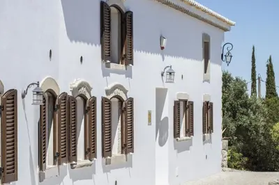 a dining room with a table and chairs and a clock at Villa Angel in Loulé