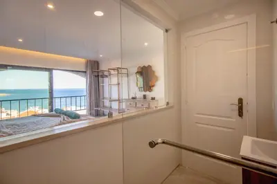 a bathroom with a shower with a view of the ocean at Infinito penthouse Luxury Best terrace Albufeira in Albufeira