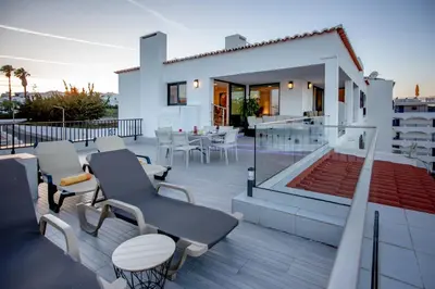 a balcony of a house with a table and chairs at Infinito penthouse Luxury Best terrace Albufeira in Albufeira