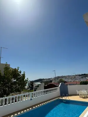 a swimming pool on the roof of a house at Vila Mar Central in Albufeira