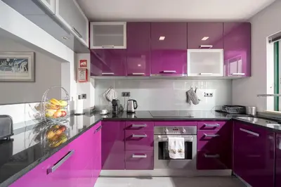 a kitchen with purple cabinets and a stove at Downtown Pool House in Faro