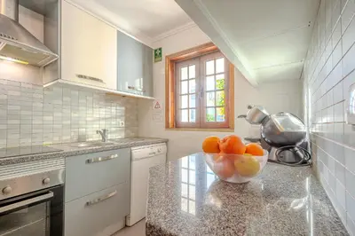 a kitchen with a bowl of fruit on a counter at T2 Casa Albufeira - Pool & Sun Terrace in Albufeira