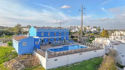 an aerial view of a blue house with a swimming pool at T2 Casa Albufeira - Pool & Sun Terrace in Albufeira