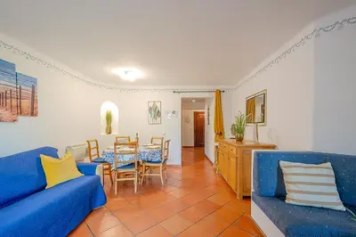 a living room with a blue couch and a table at T2 Casa Albufeira - Pool & Sun Terrace in Albufeira